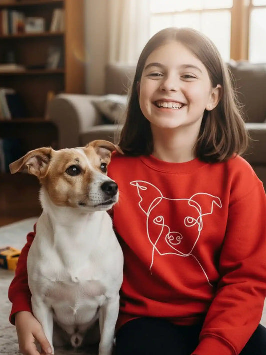 Girl wearing red custom embroidered kids hoodie with minimalist dog line art — personalized pet gift (Lovedink)