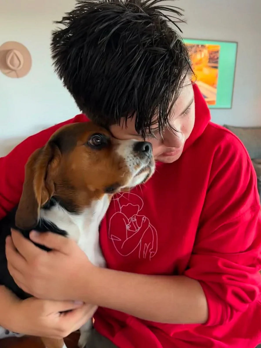Boy in red custom embroidered kids hoodie holding a small dog — personalized gift for kids