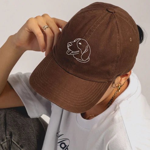 Woman wearing brown custom embroidered cap with minimalist line art portrait (Lovedink)