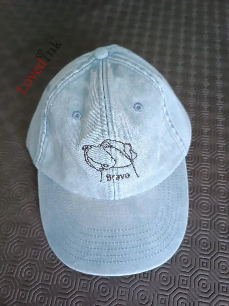 Light blue custom embroidered cap with minimalist line art — front view (Lovedink)