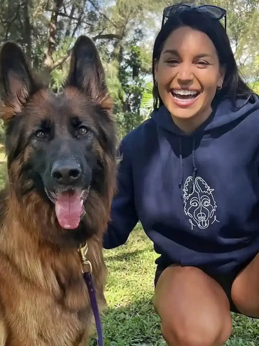 Woman with German Shepherd wearing navy custom embroidered hoodie with minimalist dog line art