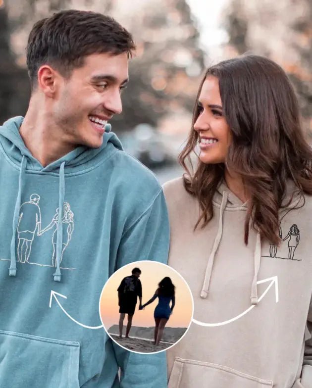 Couple wearing light blue custom embroidered hoodie with minimalist line art portrait (Lovedink)