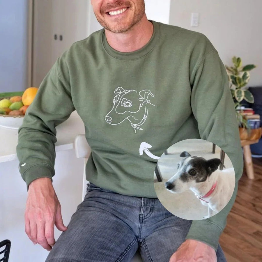 Man with dog wearing olive green custom embroidered sweatshirt with minimalist pet line art