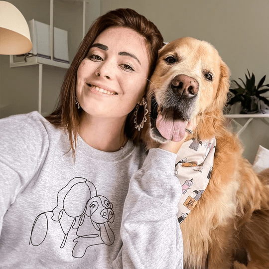 women with Golden Retriever wearing matching custom embroidered sweatshirts with minimalist dog portrait