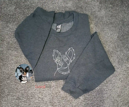 Close-up of grey custom embroidered sweatshirt with minimalist Husky line art portrait (Lovedink)