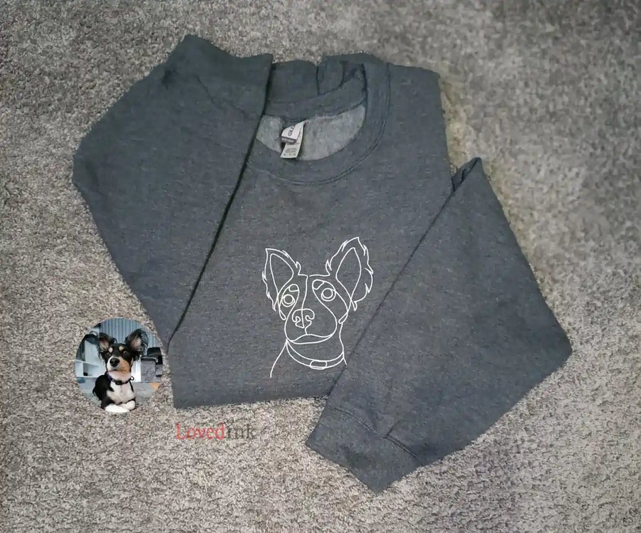 Close-up of grey custom embroidered sweatshirt with minimalist Husky line art portrait (Lovedink)