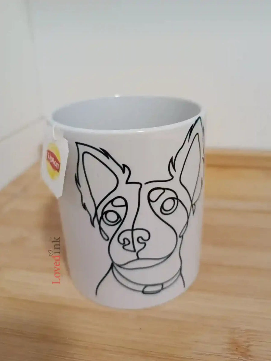 White mug with custom minimalist line art print on wooden table (Lovedink)