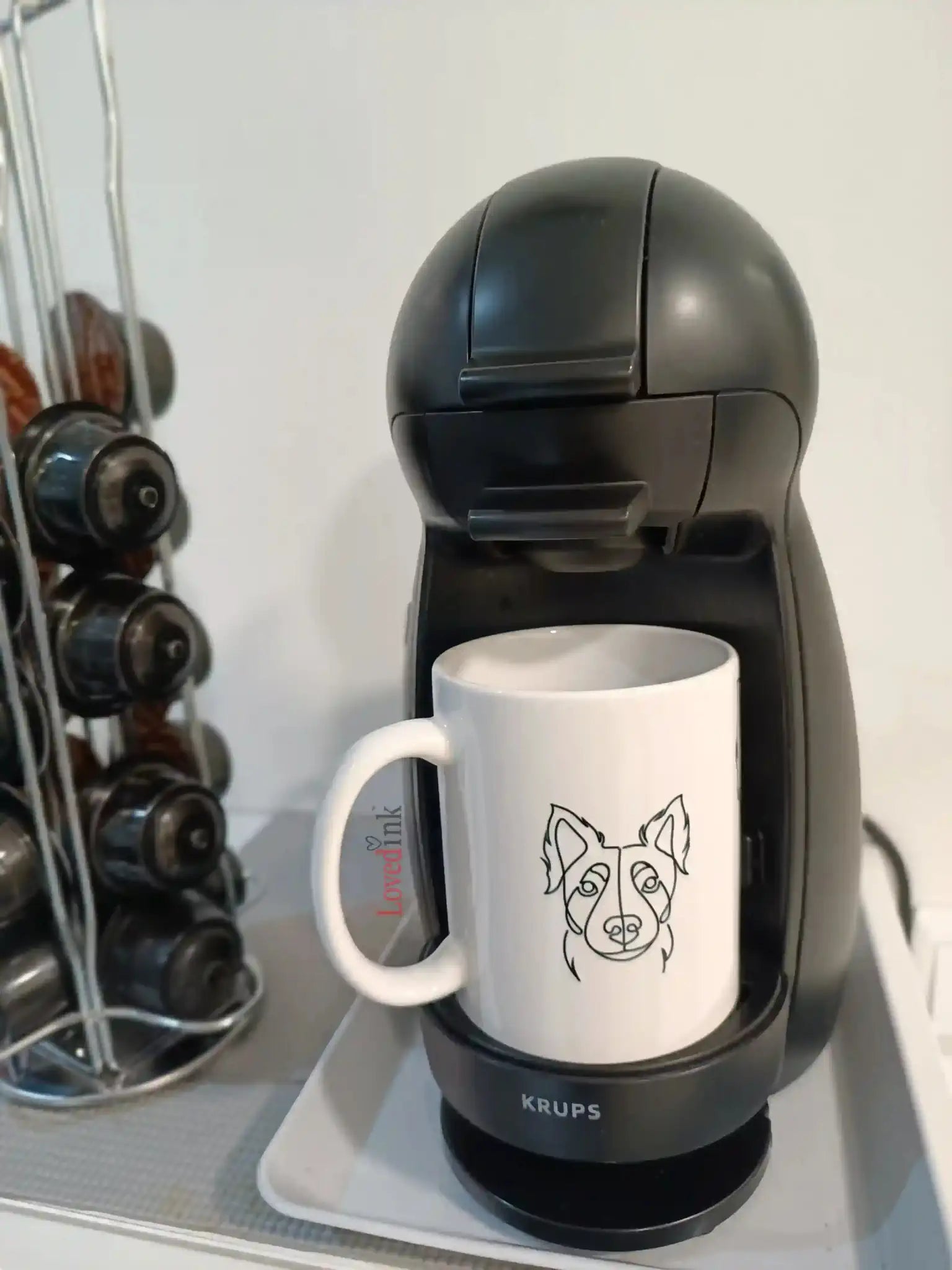 Custom minimalist line art mug next to coffee machine (Lovedink)